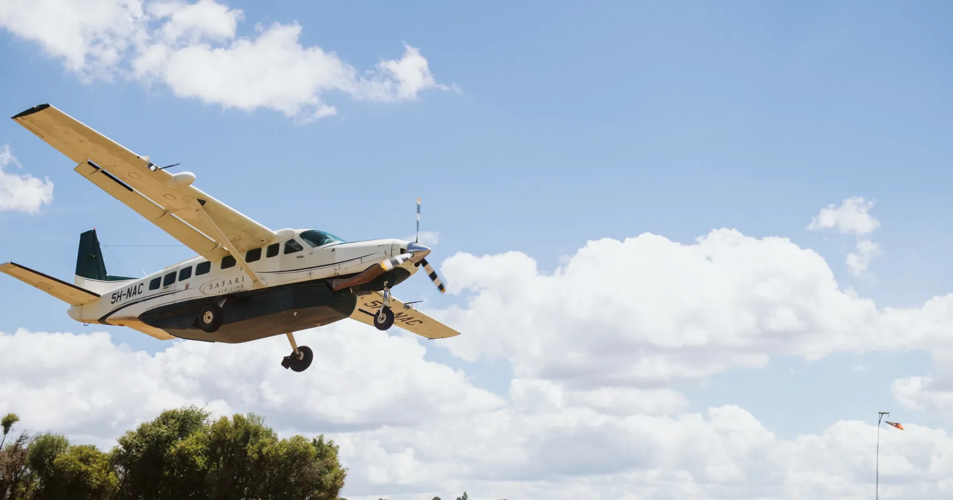 Fly-in safari — bush plane landing in Tanzania wilderness